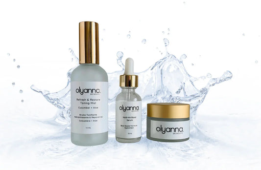 Olyanna skincare products including a bottle, dropper, and jar on a water splash background.